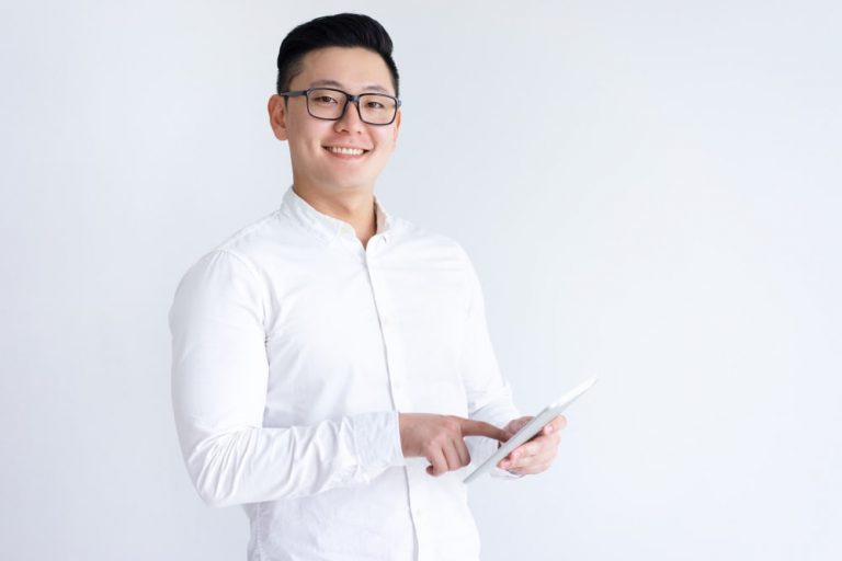 smiling-asian-man-using-tablet-computer-min